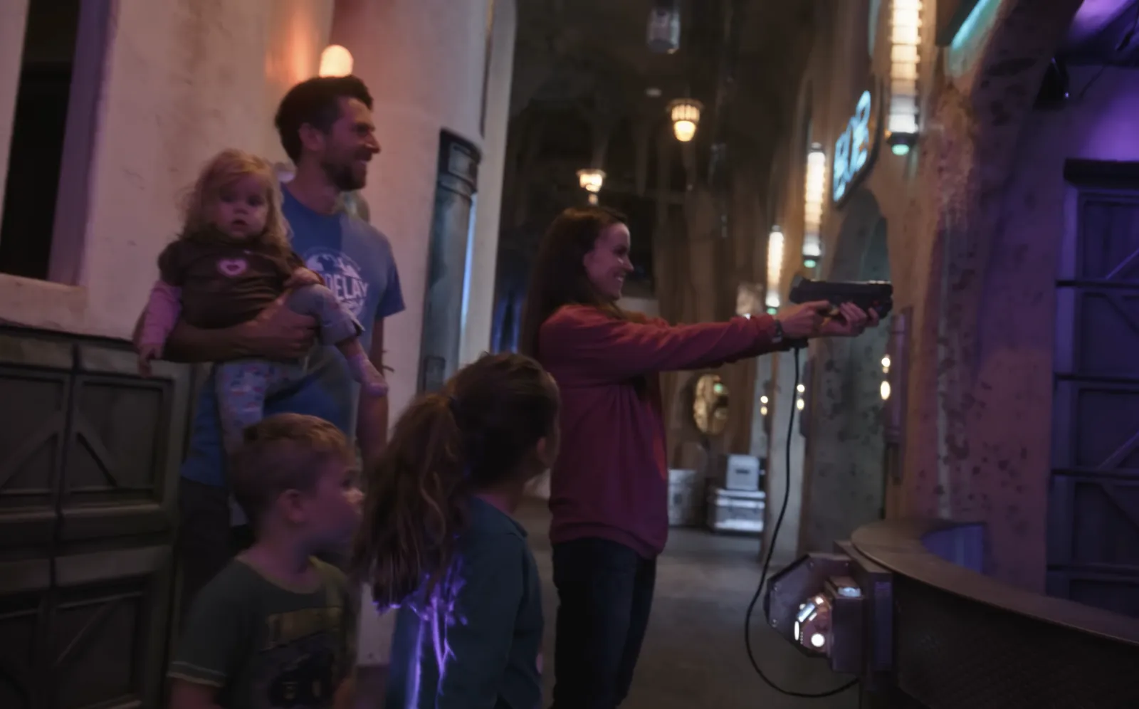 A family playing a laser gun game